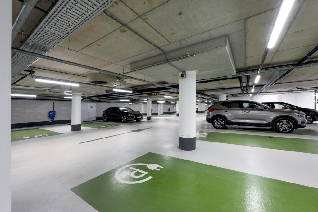 Underground parking garage on Mr. Treublaan with designated electric vehicle charging spaces.